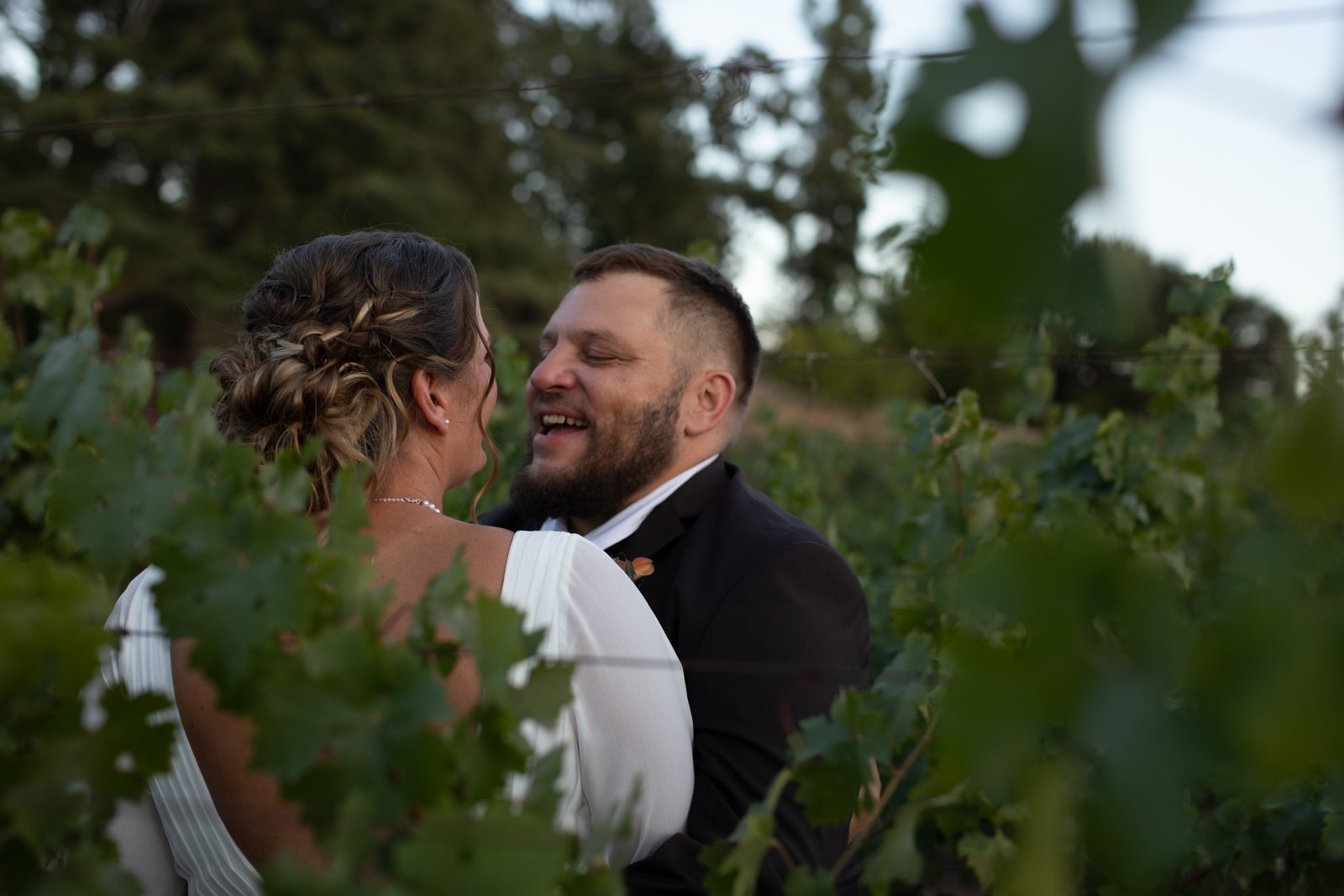 Amy and Jim - Couple laughing in vineyard